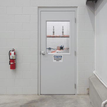 Fiberglass-Pedestrian-Door fiberglass pedestrian door with a window and sign that reads notice, authorized personnel only