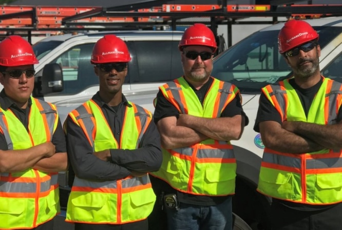 service-1 Four Allmark employees in high-visibility vests.