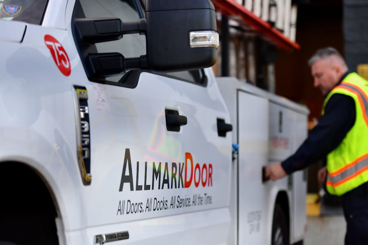 Close up of Allmark branded car with an employee in the background